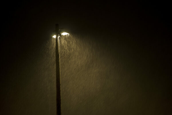 Lamp post at night in heavy snow storm